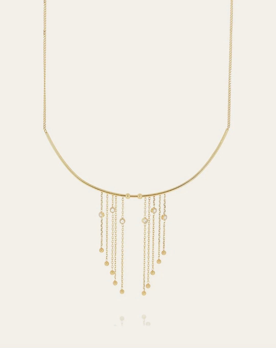 Collana dorata con frange e zirconi
